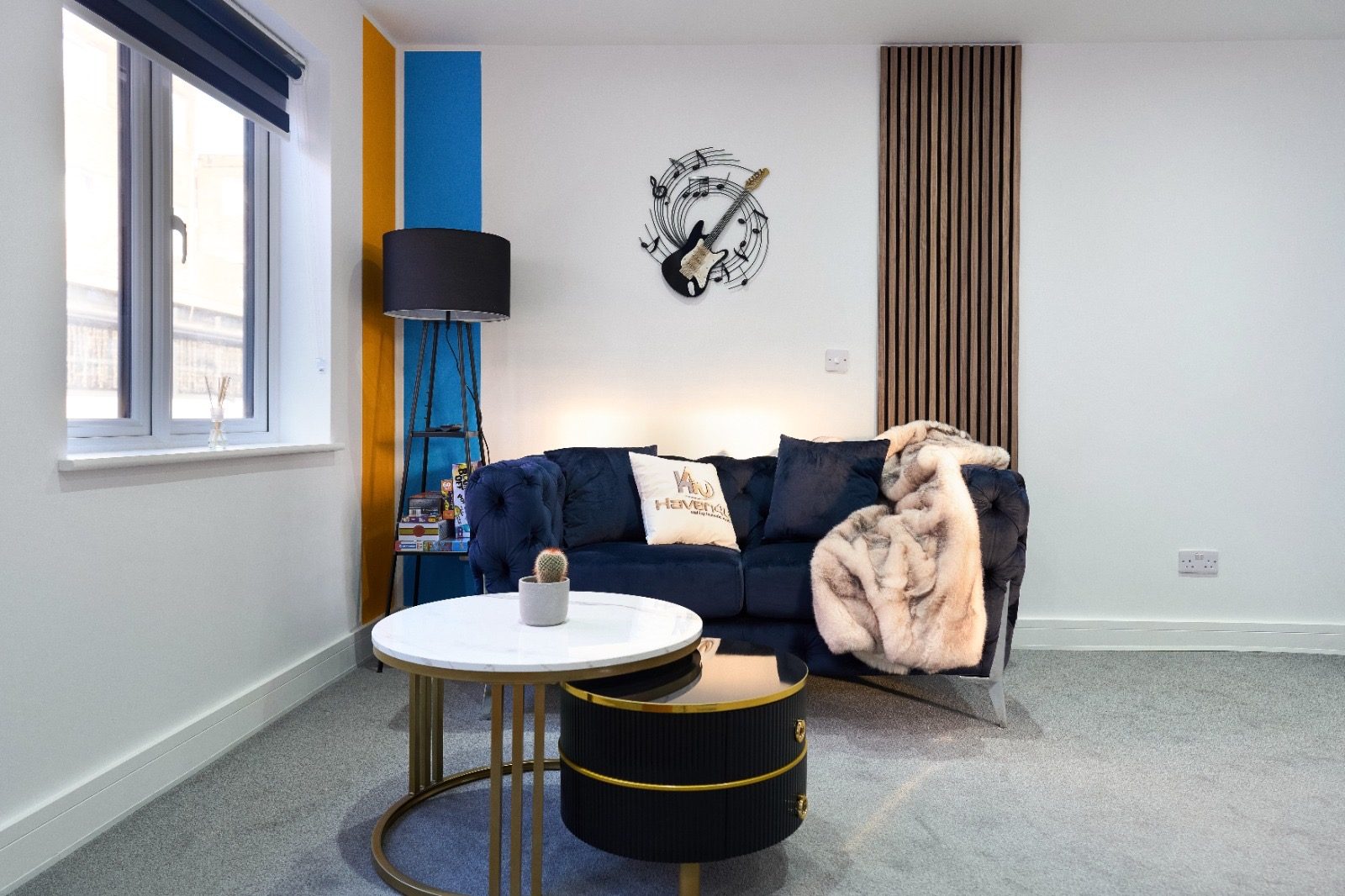 Navy velvet sofa and oak slat wall in The Pop Art House