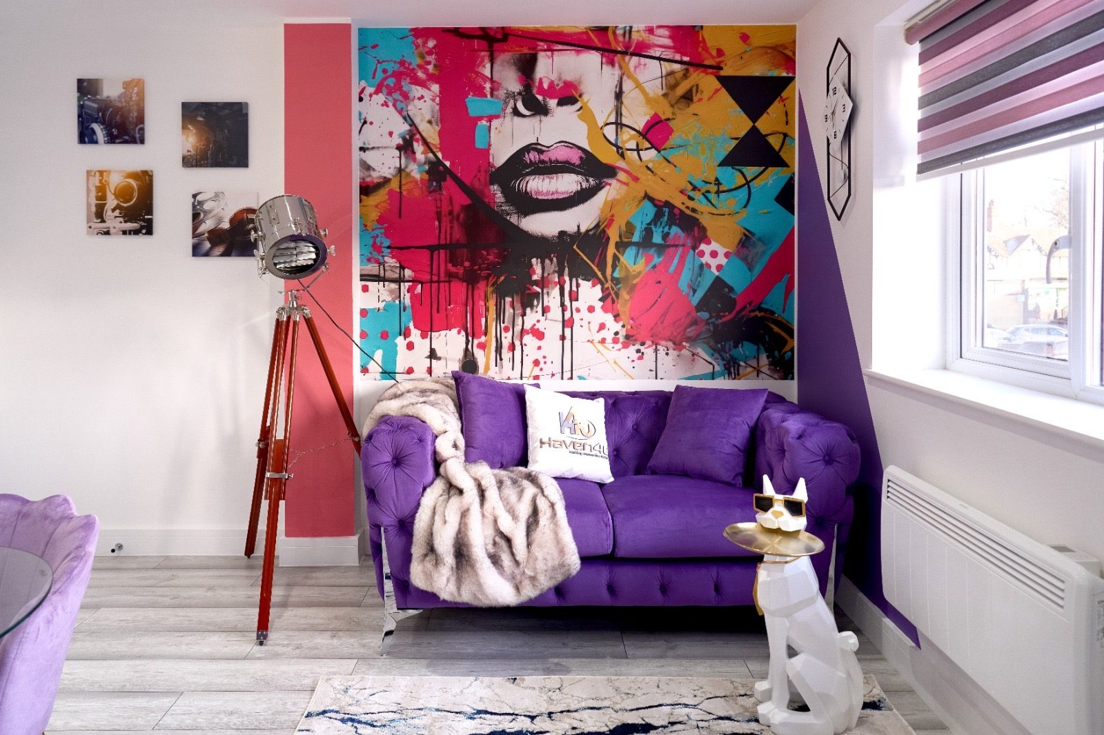 Purple chesterfield sofa in front of a graffiti mural