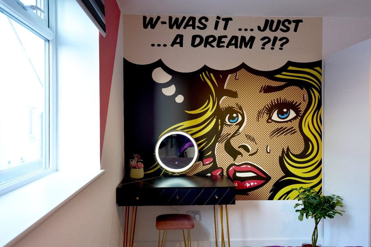 Lit vanity mirror against a pop-art comic panel