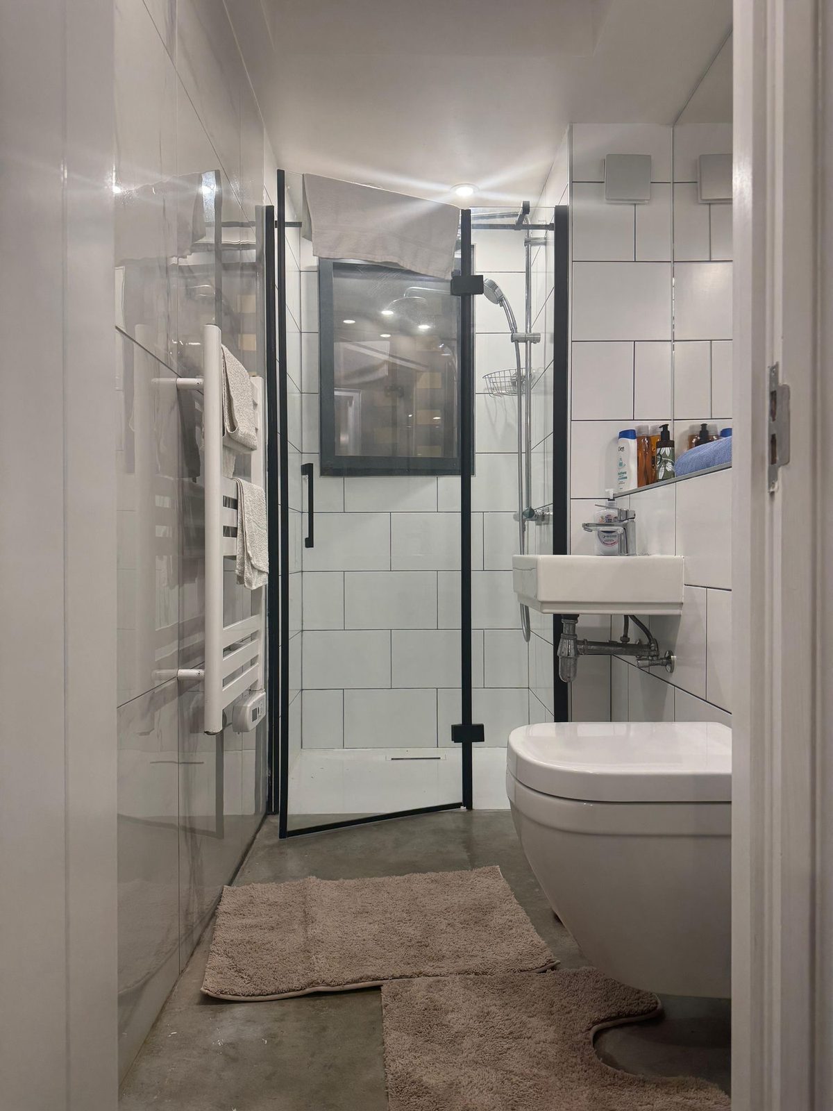 Tiled shower room with walk-in glass enclosure