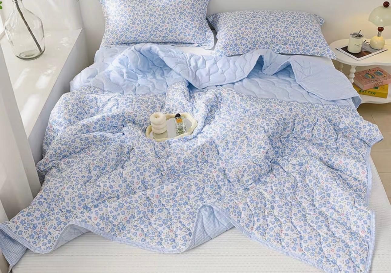 Bed made up with fresh floral cotton bedding